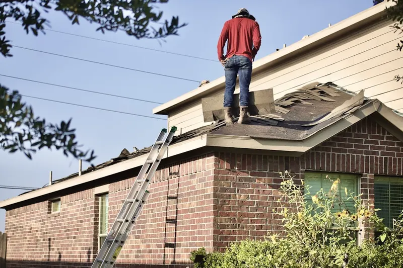 Professional roofer working on a residential roof in Providence Lakes